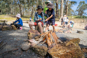 Children tending to campfire