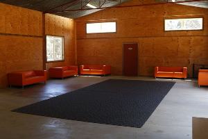 Empty barn hall. Concrete floor, wooden walls and tin celling