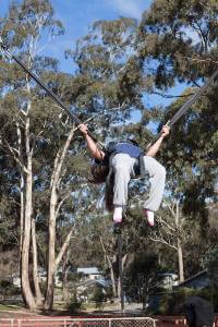 Girl doing backflip on bungee trampoline