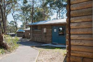 Four log cabin in a row down the hill