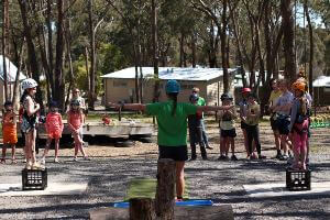 Instructor give school group instructions before starting milk crate stacking