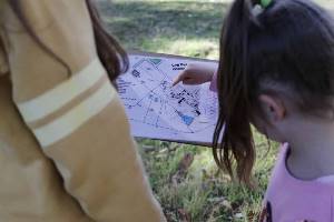 Girl pointing to orienteering map