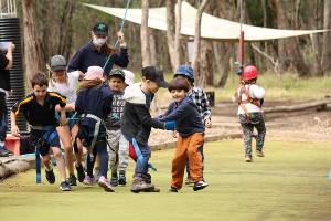 Kids running on possum glider pull team