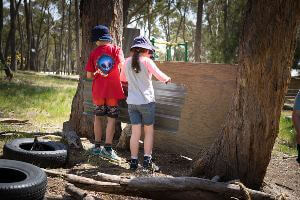 Two Students adding roof iron to bush hut