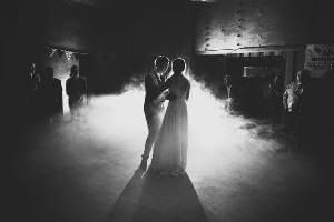 Bridal couple having their first dance in the barn hall