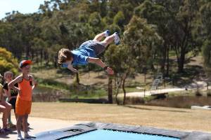 Boy doing backflip on trampoline